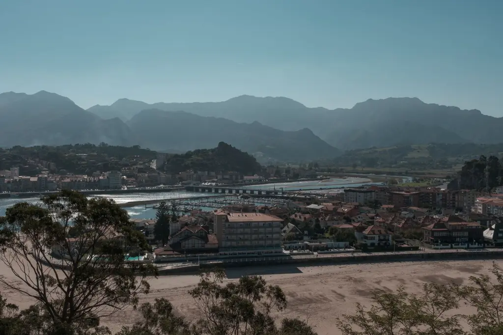 Asturias: Scenic view of a coastal town in Asturias with mountains in the background, Spain.