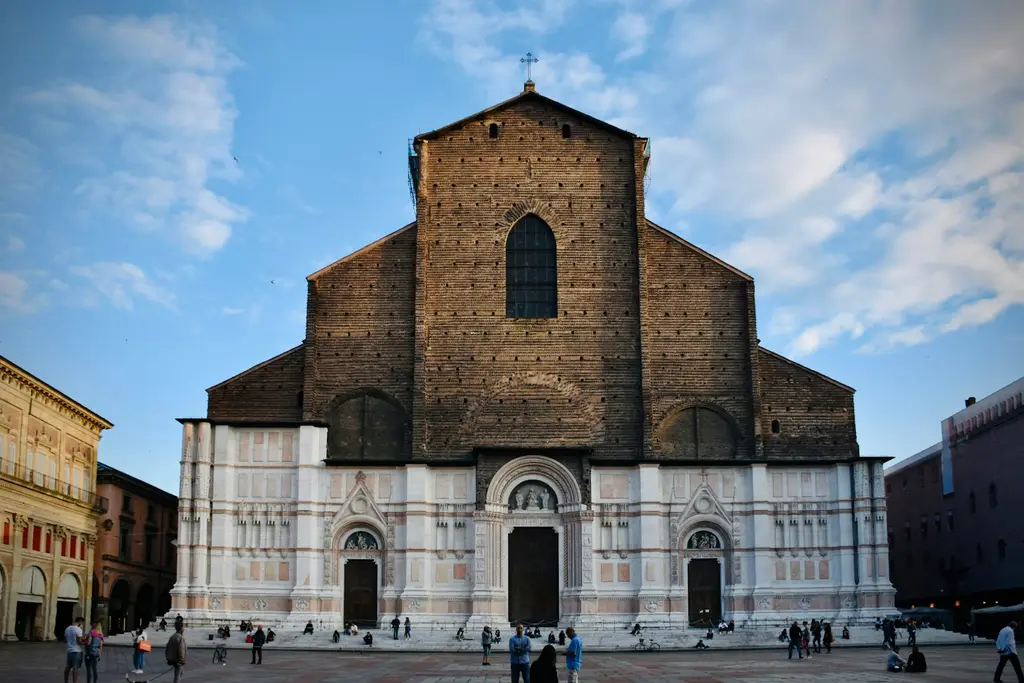 Bologna: Great Rennaissance cathedral of San Petronio in Bologna, on its main Square Piazza Maggiore, on a nice early June evening, in the perfect blue hour. brown concr