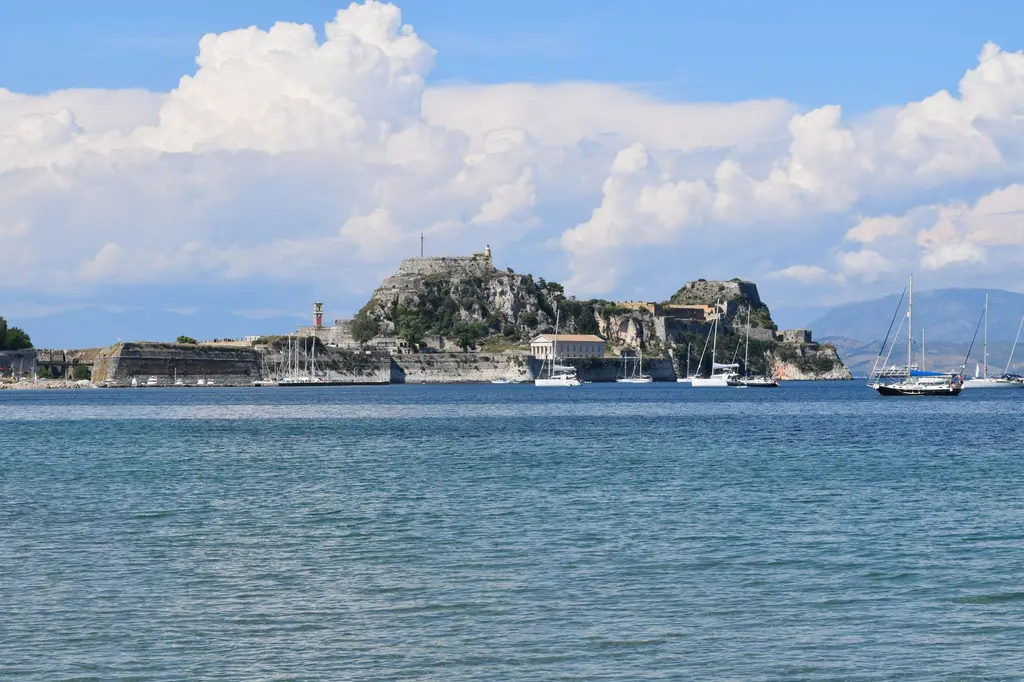Corfu: Scenic view of Corfu's old fortress and sailboats under a blue sky.