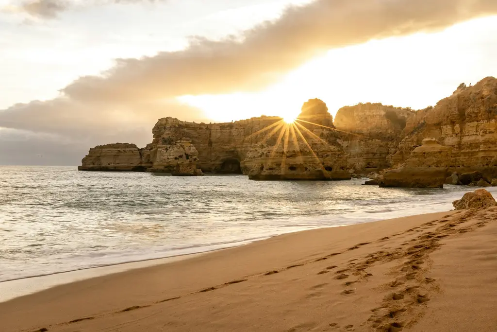 Algarve: The stunningly beautiful coast of the Algarve, Portugal. Praia da Marinha at it's finest! brown rock formation on sea shore during sunset