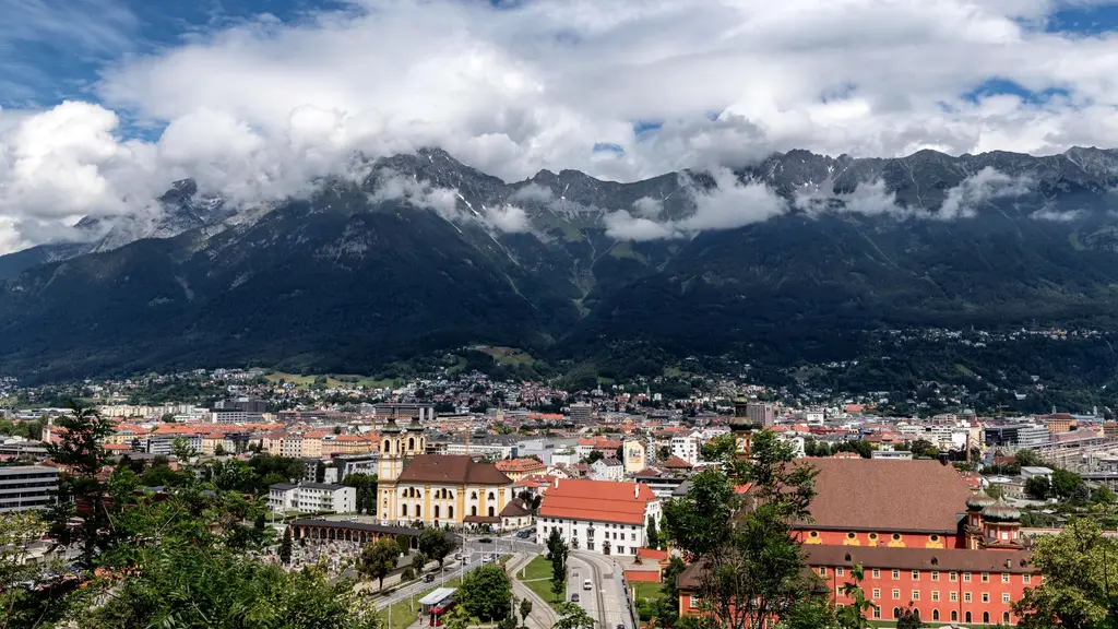 Innsbruck: A breathtaking aerial view of Innsbruck, Austria, framed by majestic mountains and vibrant urban life.