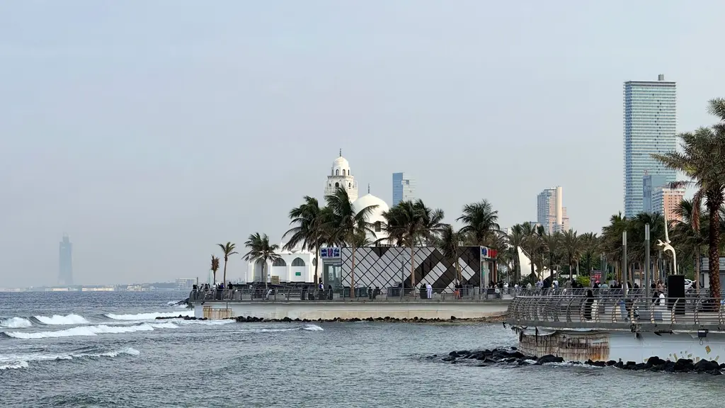 Jeddah: Morning view of Jeddah Corniche with palm trees and ocean waves, capturing Saudi Arabia's coastal beauty.