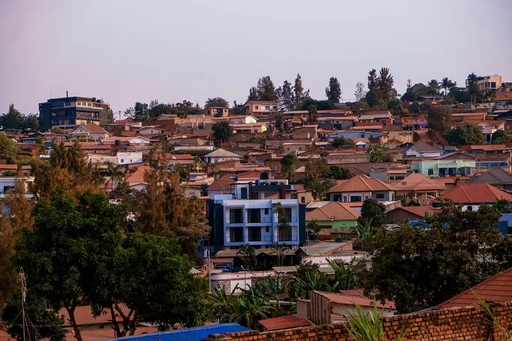 Kigali: A vibrant panorama of Kigali's residential area showcasing architecture and greenery at sunset.