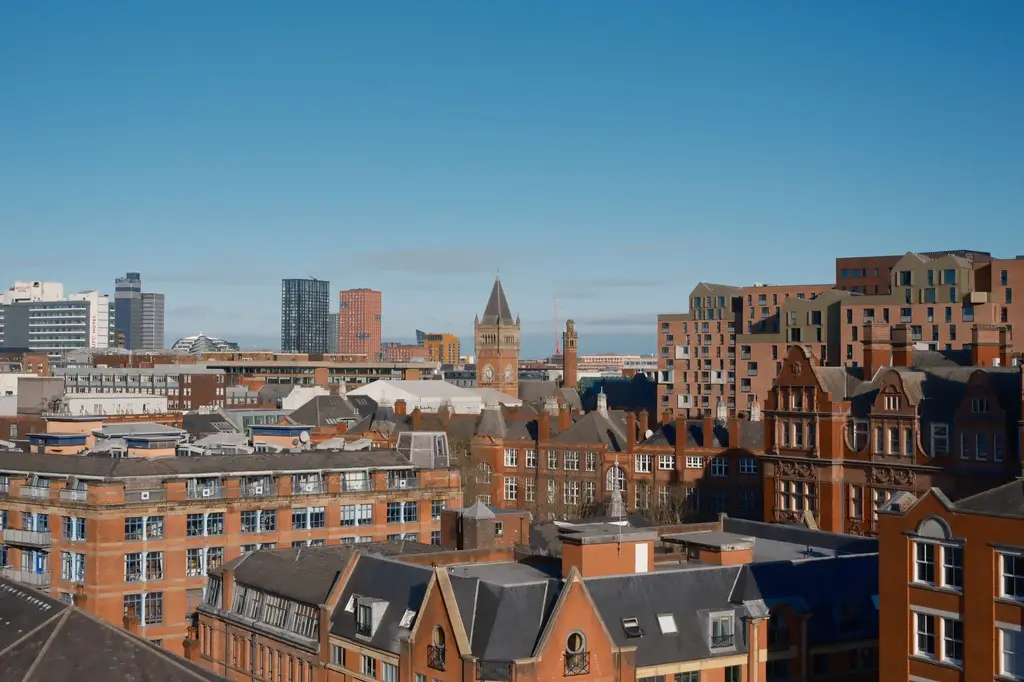 Manchester: A vibrant view of Manchester showcasing modern and classic architecture under a clear sky.