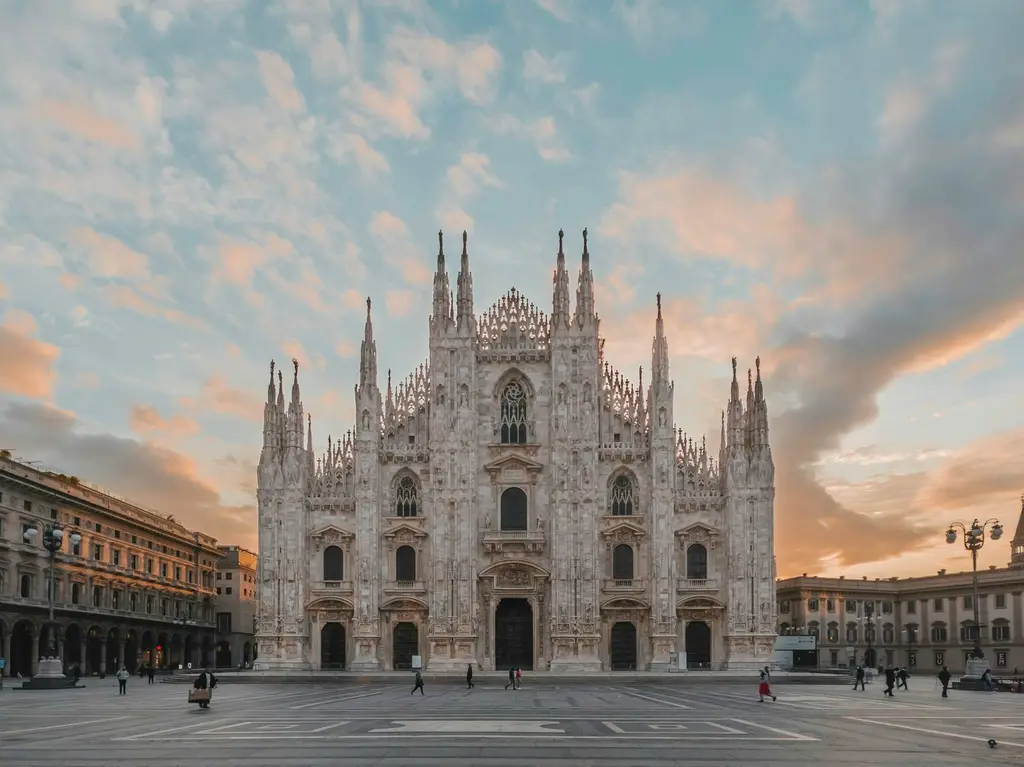 Milan: For any use contact me on Instagram (@benwksi) The Duomo di Milano cathedral in Milan under a soft orange and blue sky