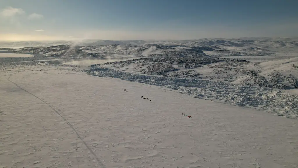 Greenland: Aerial view of a vast snowy landscape in Greenland showcasing the beauty of winter terrain.