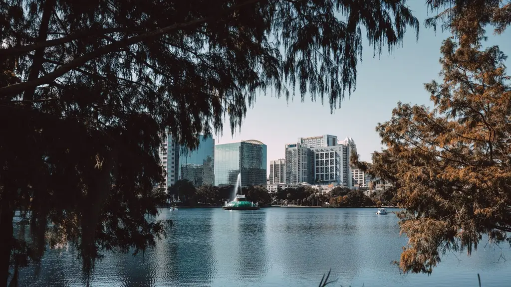 Orlando: Captivating view of downtown Orlando skyline framed by trees at Lake Eola.