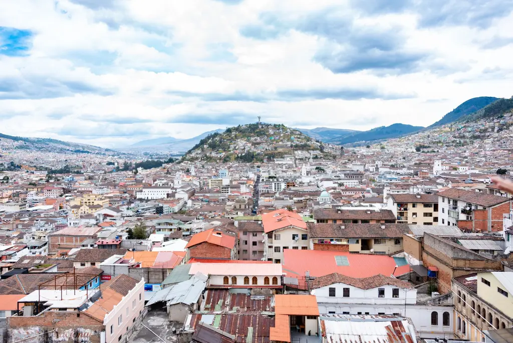 Quito: Aerial view showcasing Quito's urban landscape with rolling hills and colorful rooftops.