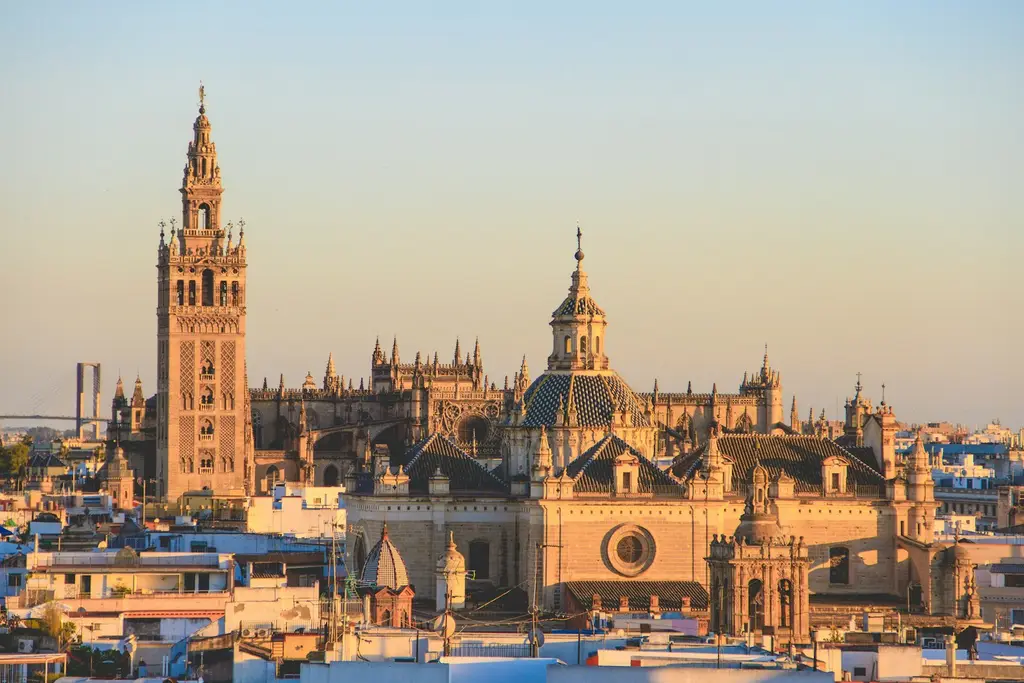 Seville: Seville Sunset The Giralda tower and Seville Cathedral rising above the city rooftops in Seville, Spain