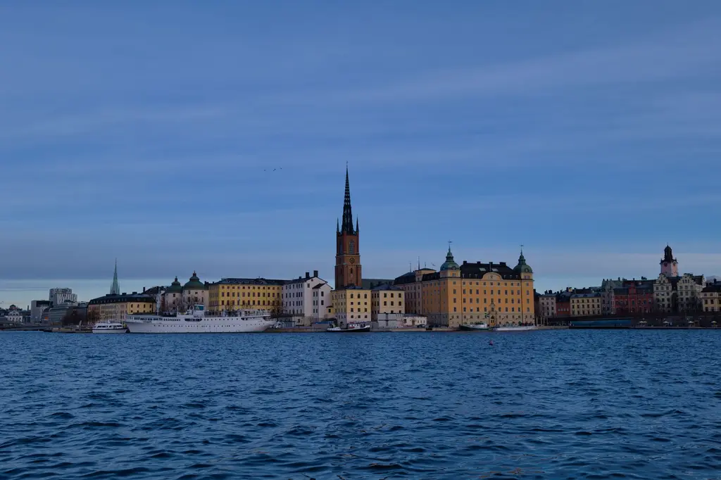 Stockholm: Skyline of Stockholm with historic architecture reflecting on water under a clear sky.