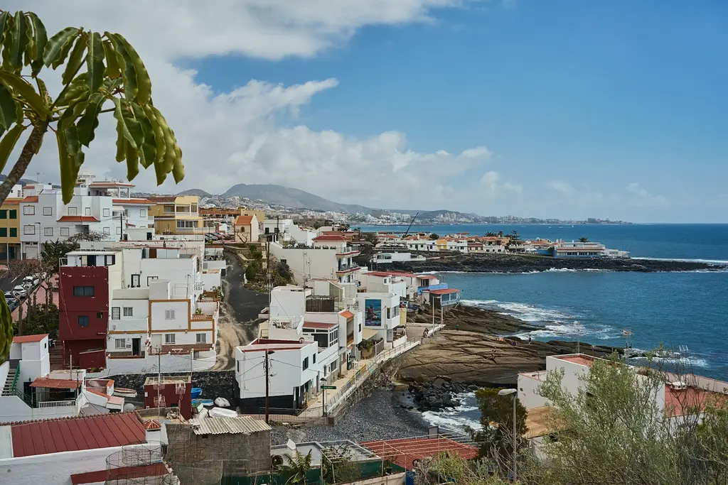 Tenerife: A small coastal town on the Canary Island of Tenerife. white and brown concrete buildings near sea under blue sky during daytime
