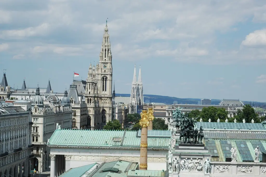 Vienna: Aerial view of Vienna showcasing the town hall, Votivkirche, and architectural landmarks.